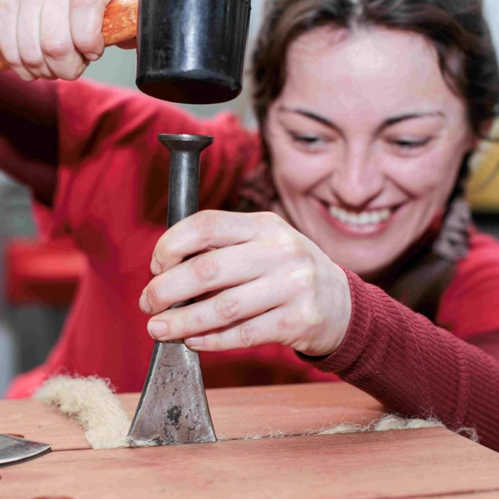 staff member working with tools, smiling